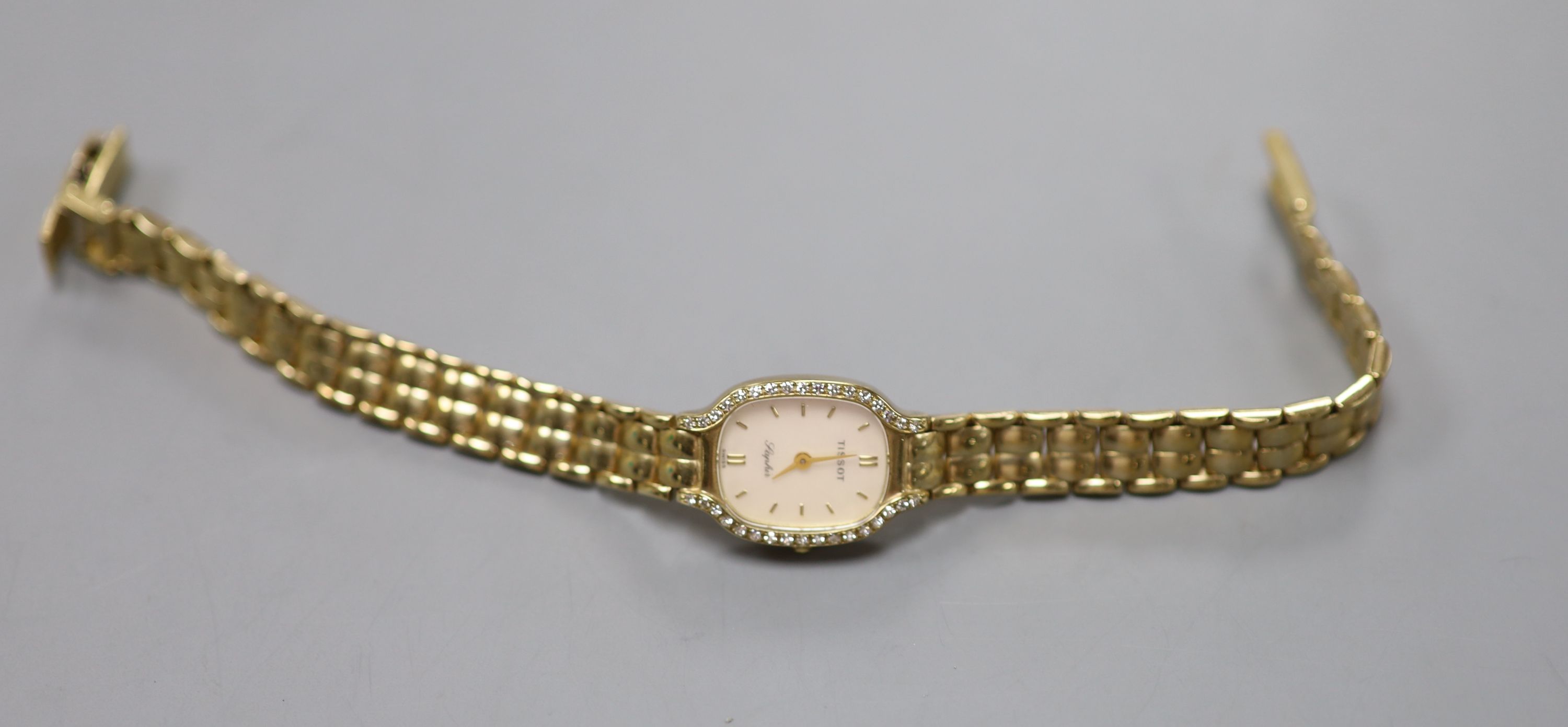 A lady's modern 9ct gold and diamond set Tissot Saphir quartz? wrist watch, 18.5cm